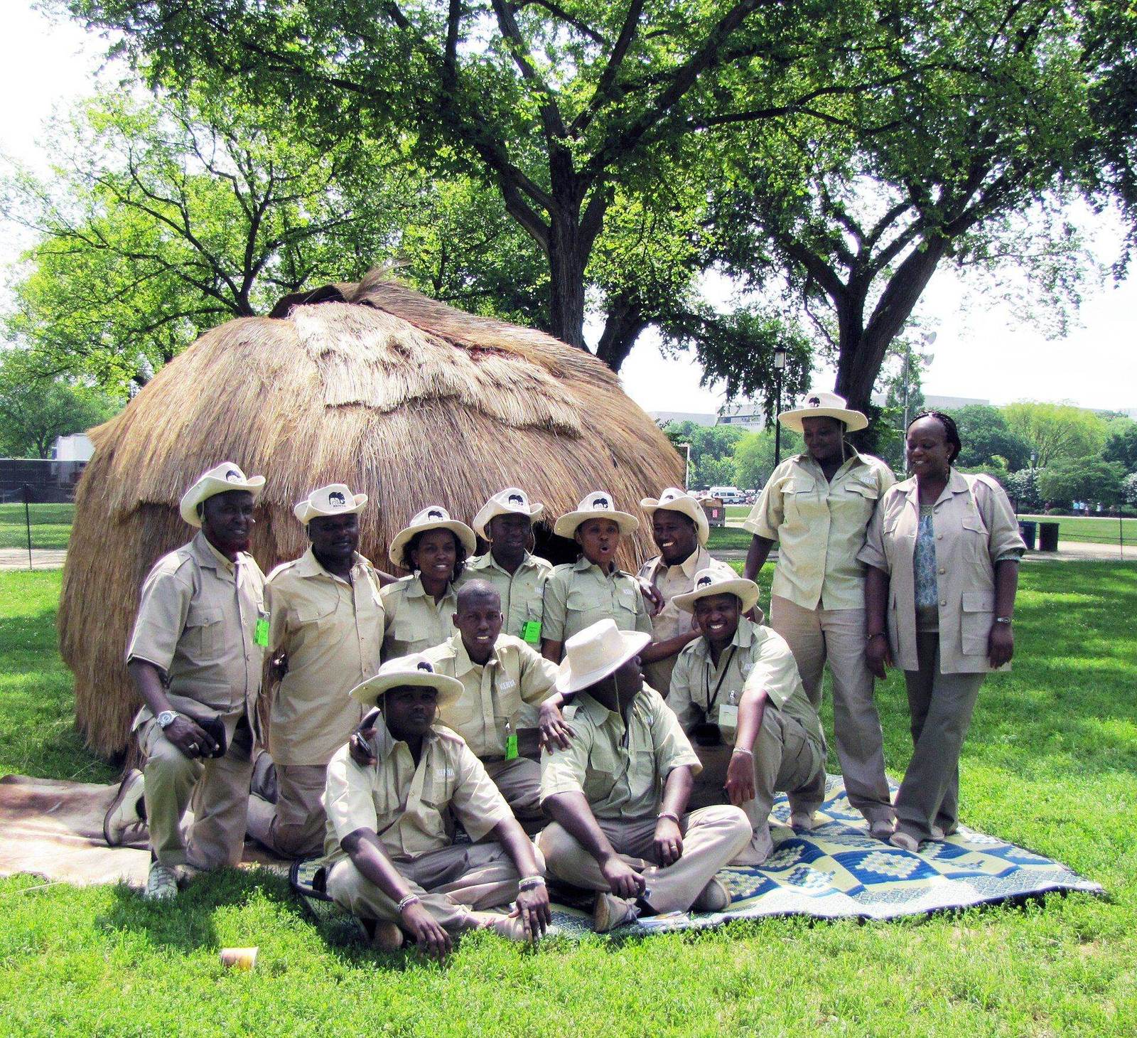 A group of uniformed CAWI field staff and volunteers posing together